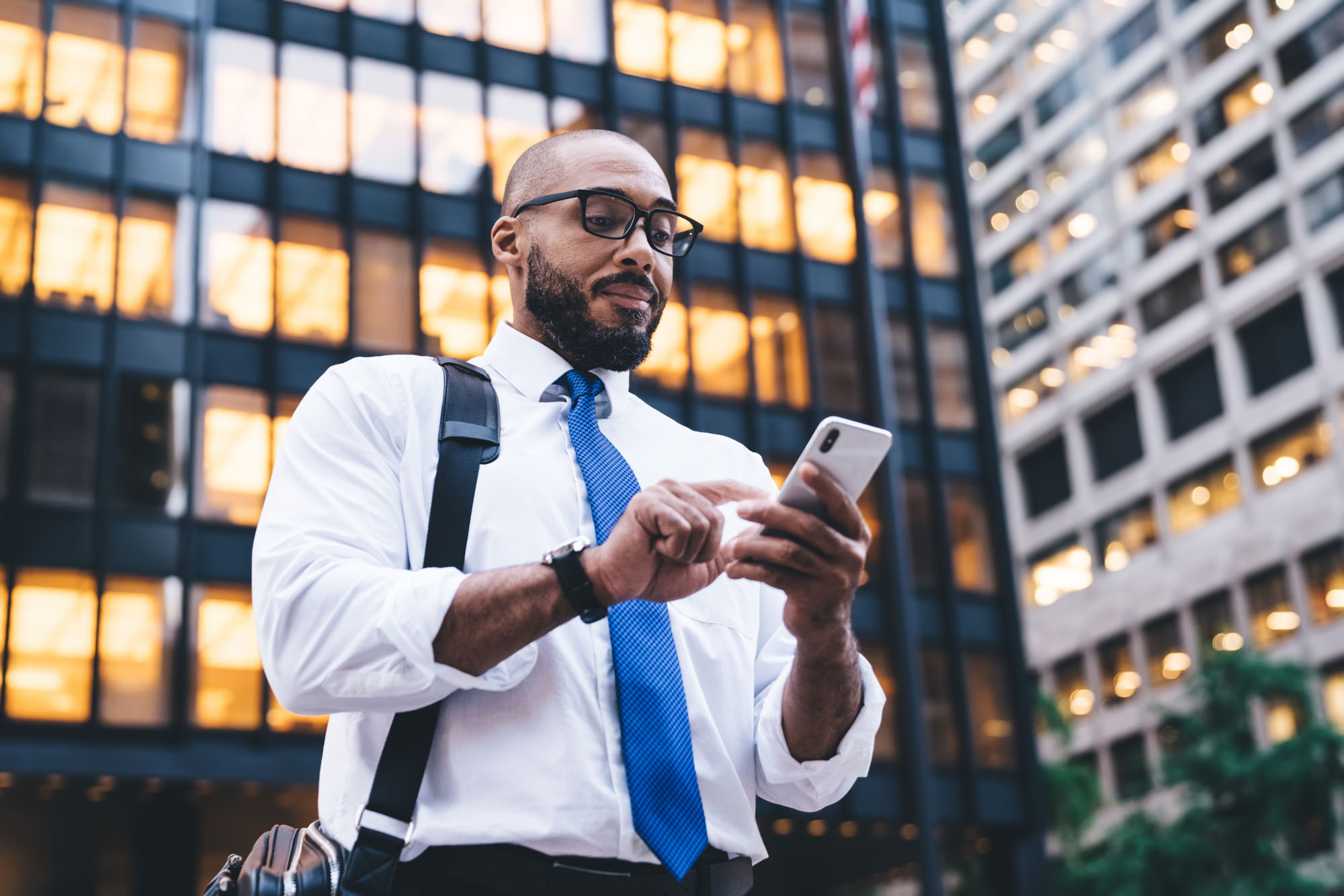 Man on phone walking through city