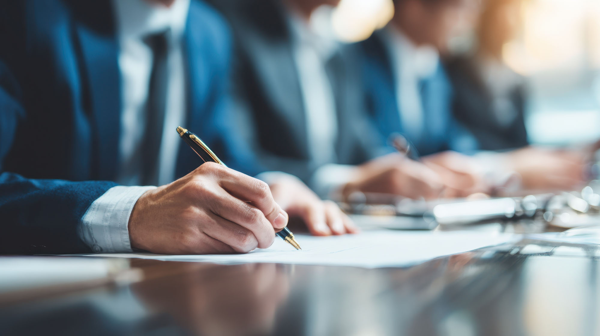People writing at desk