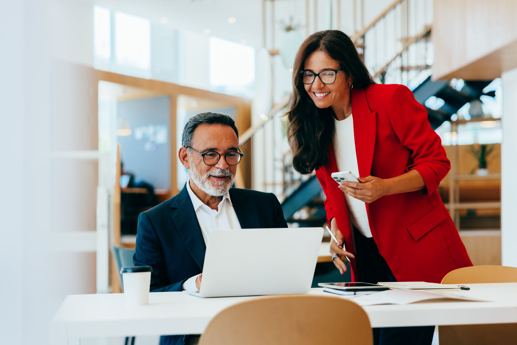 2 people smiling over a laptop