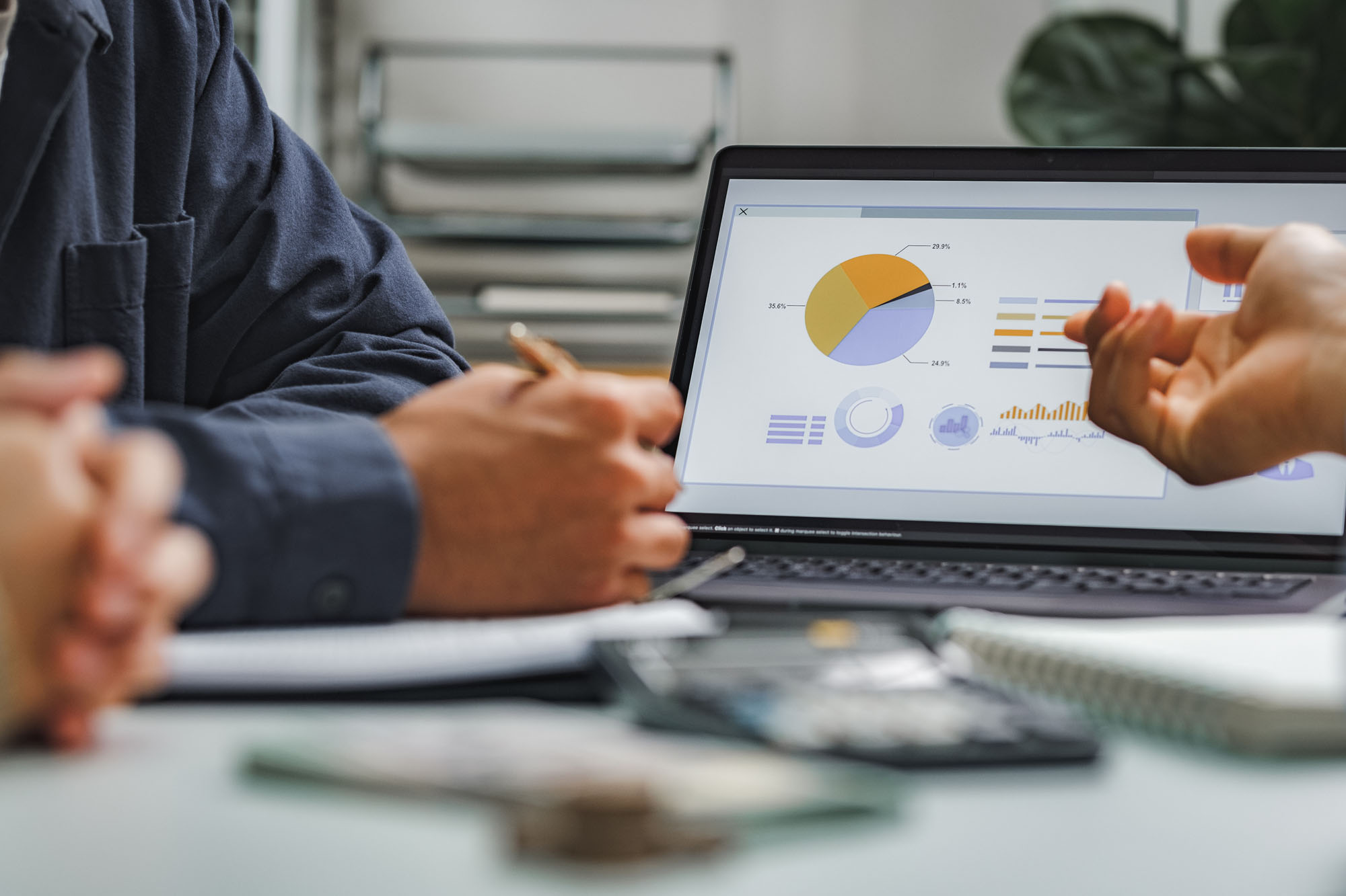 People looking at graphs on a laptop