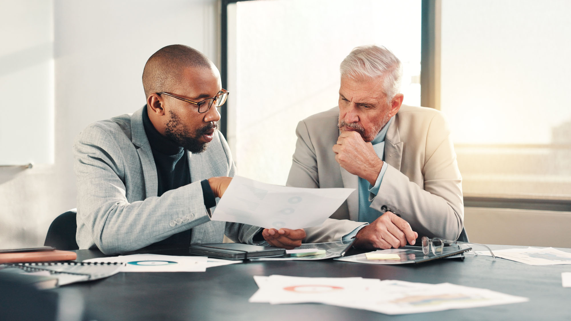2 people talking over a business plan