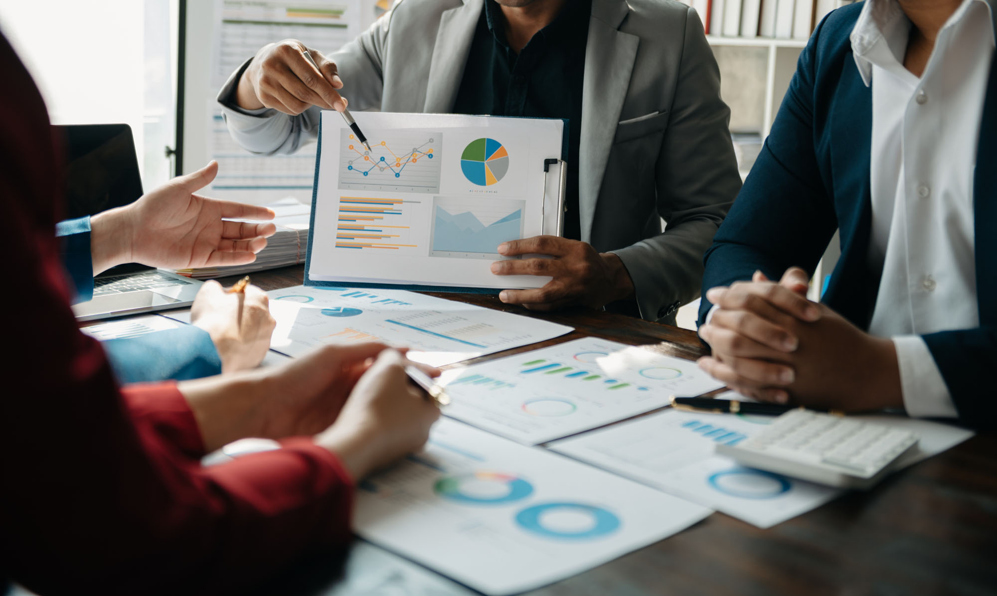 A business meeting full of charts and graphs