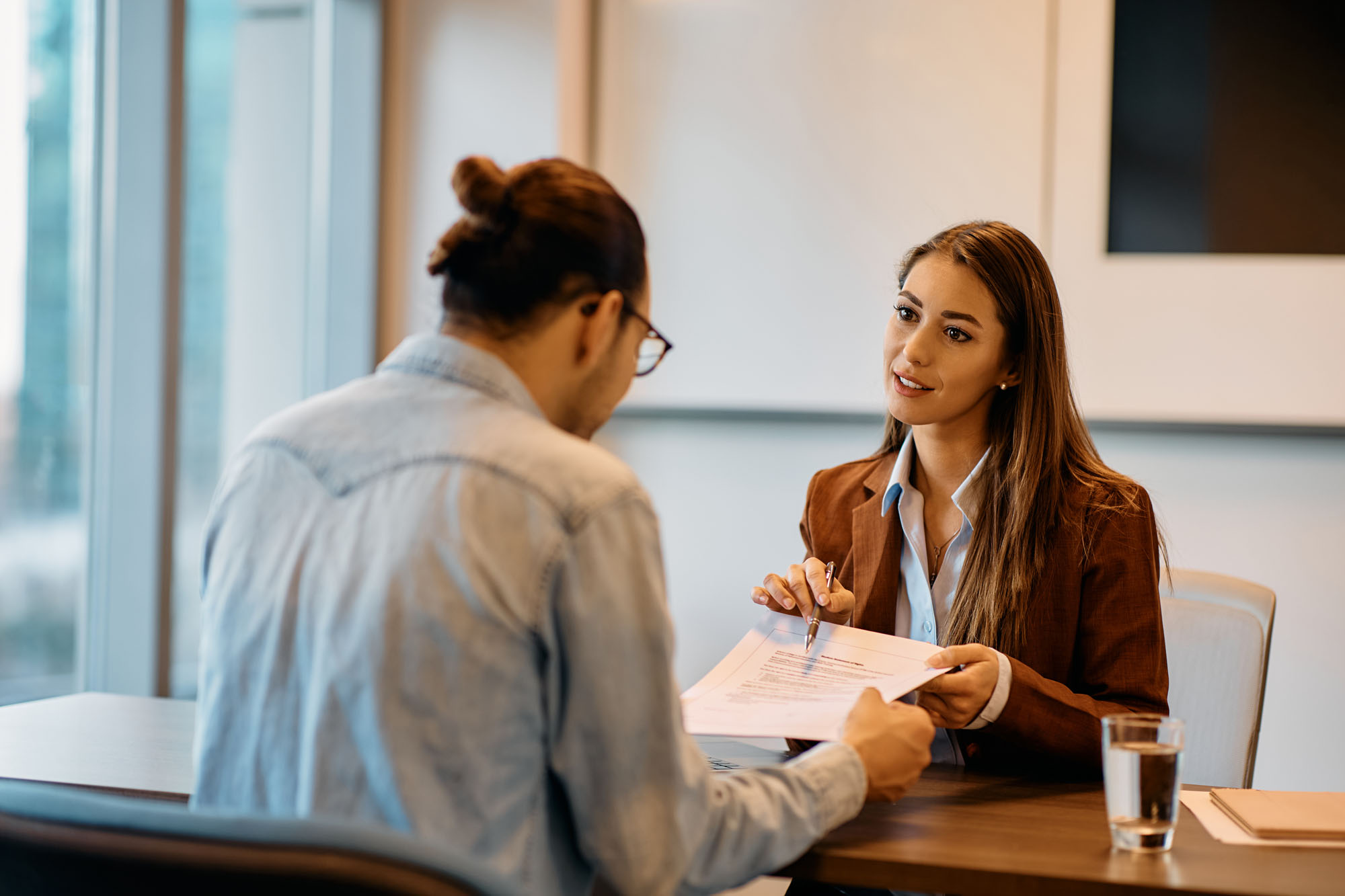 Woman explaining business operations to a man