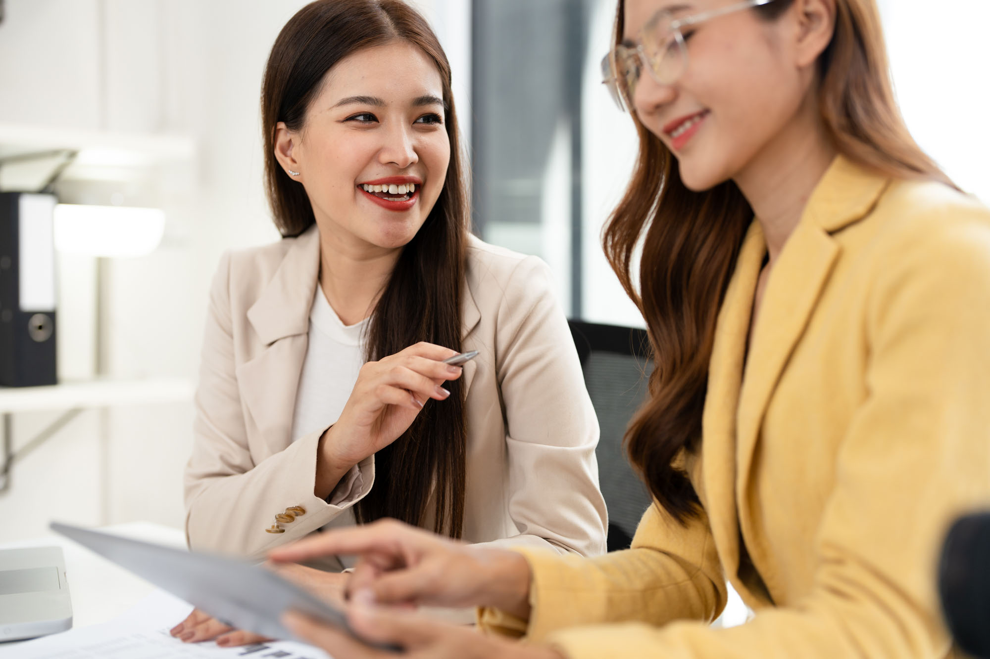 2 happy women working