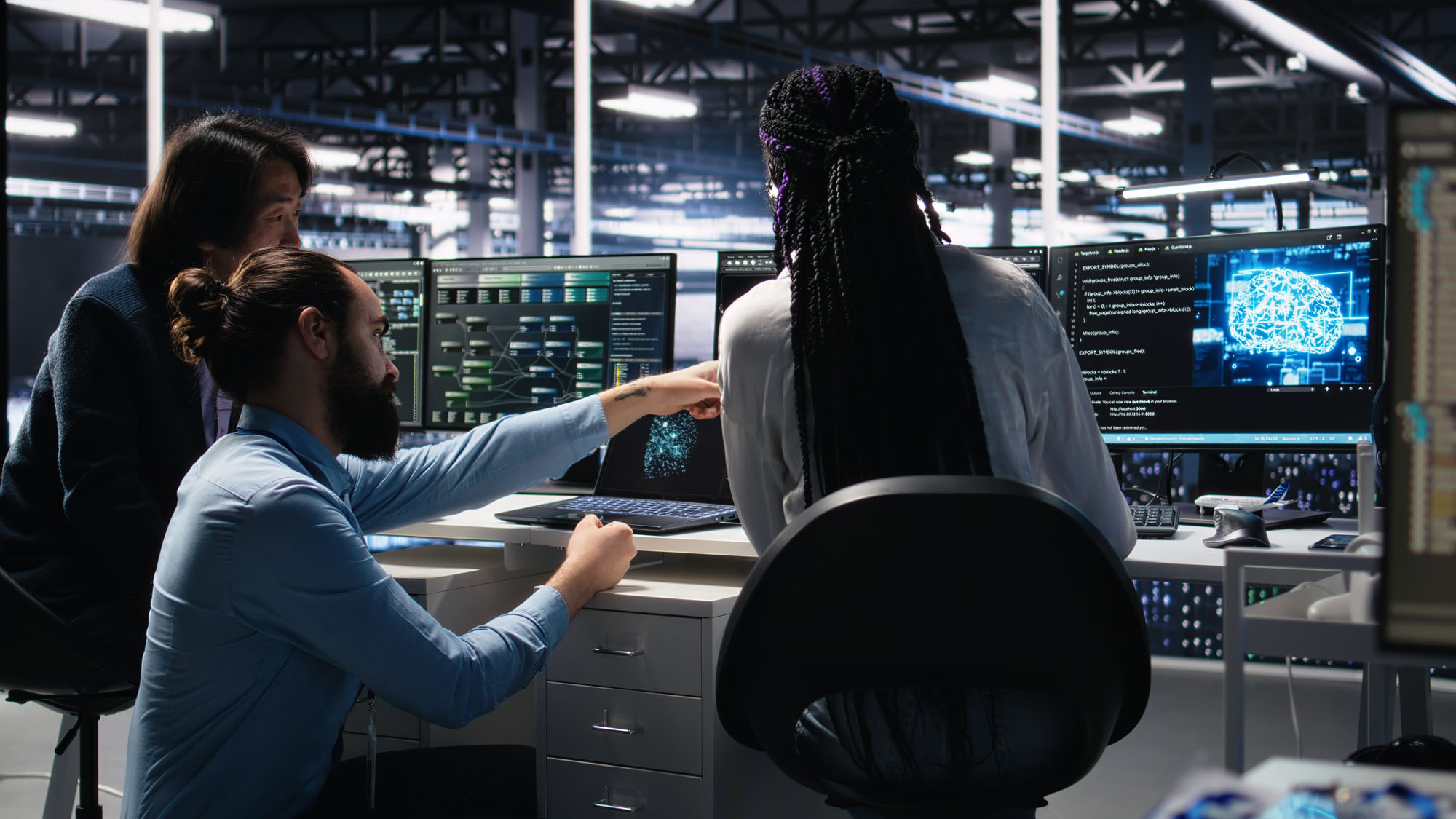 IT workers collaborating on computer