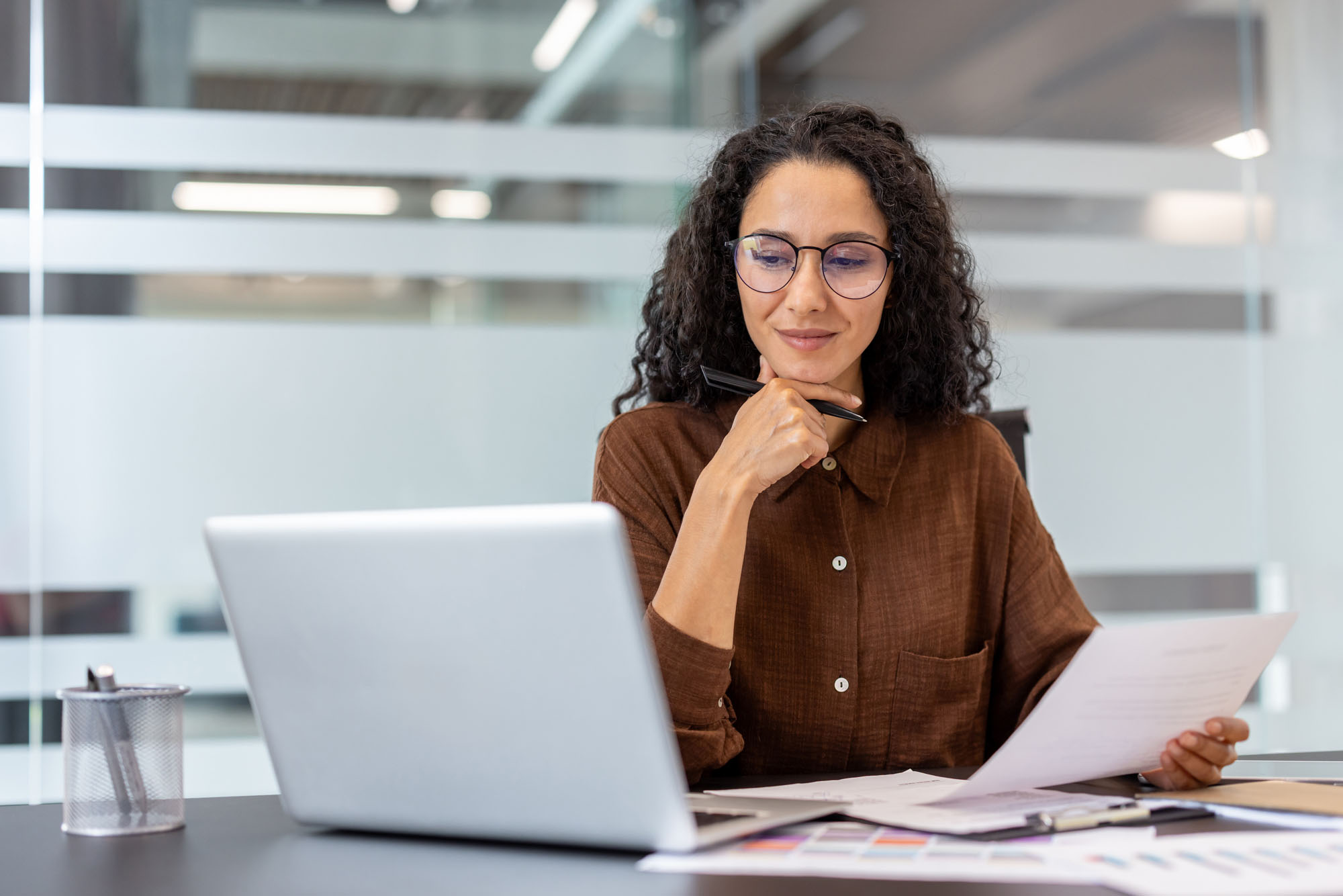 Confident woman working at laptop